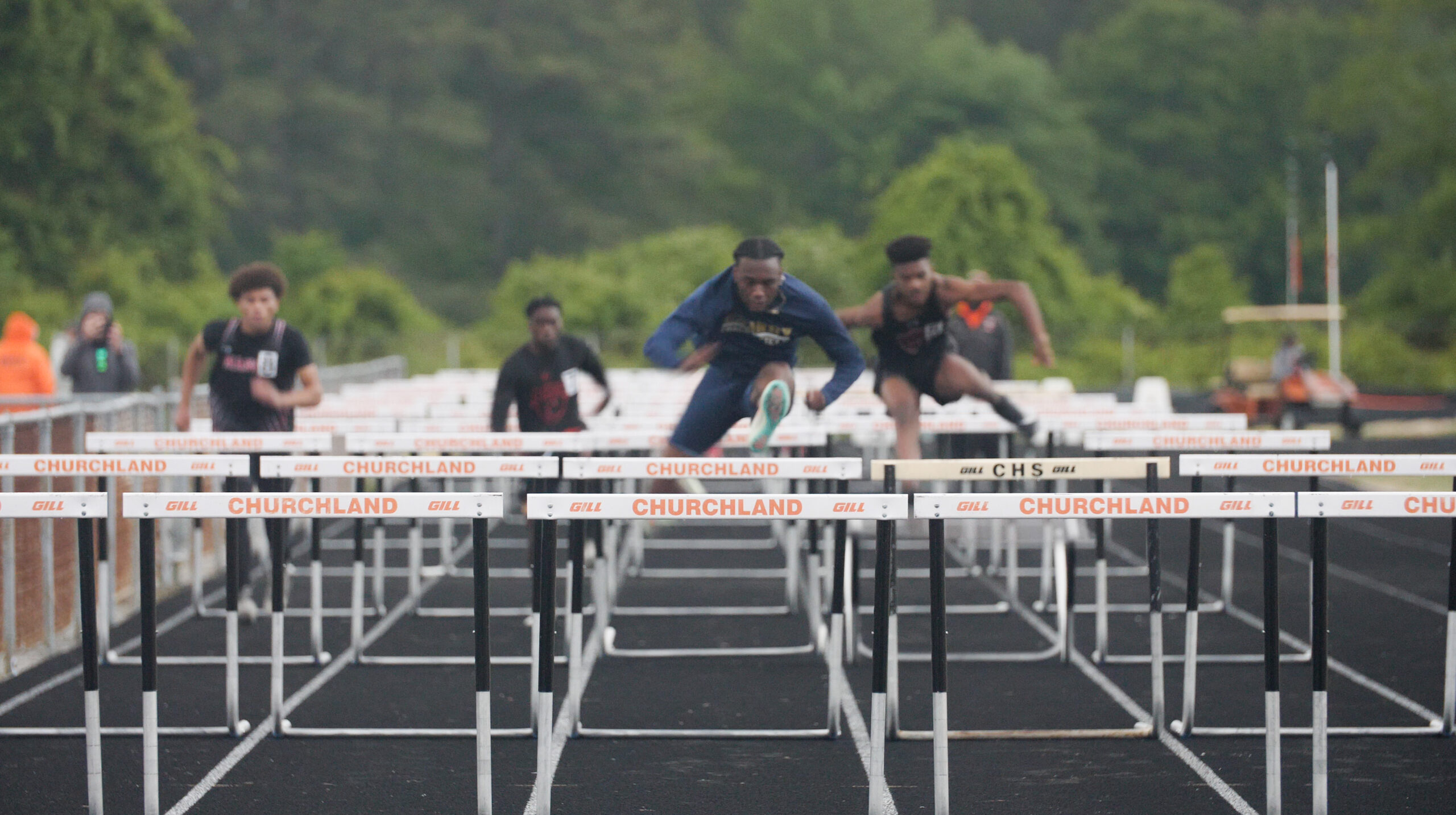 churchland high school track team jumping hurdles